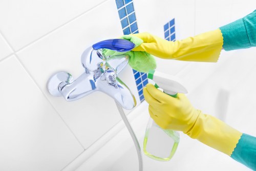 Trained carpet cleaner using protective equipment